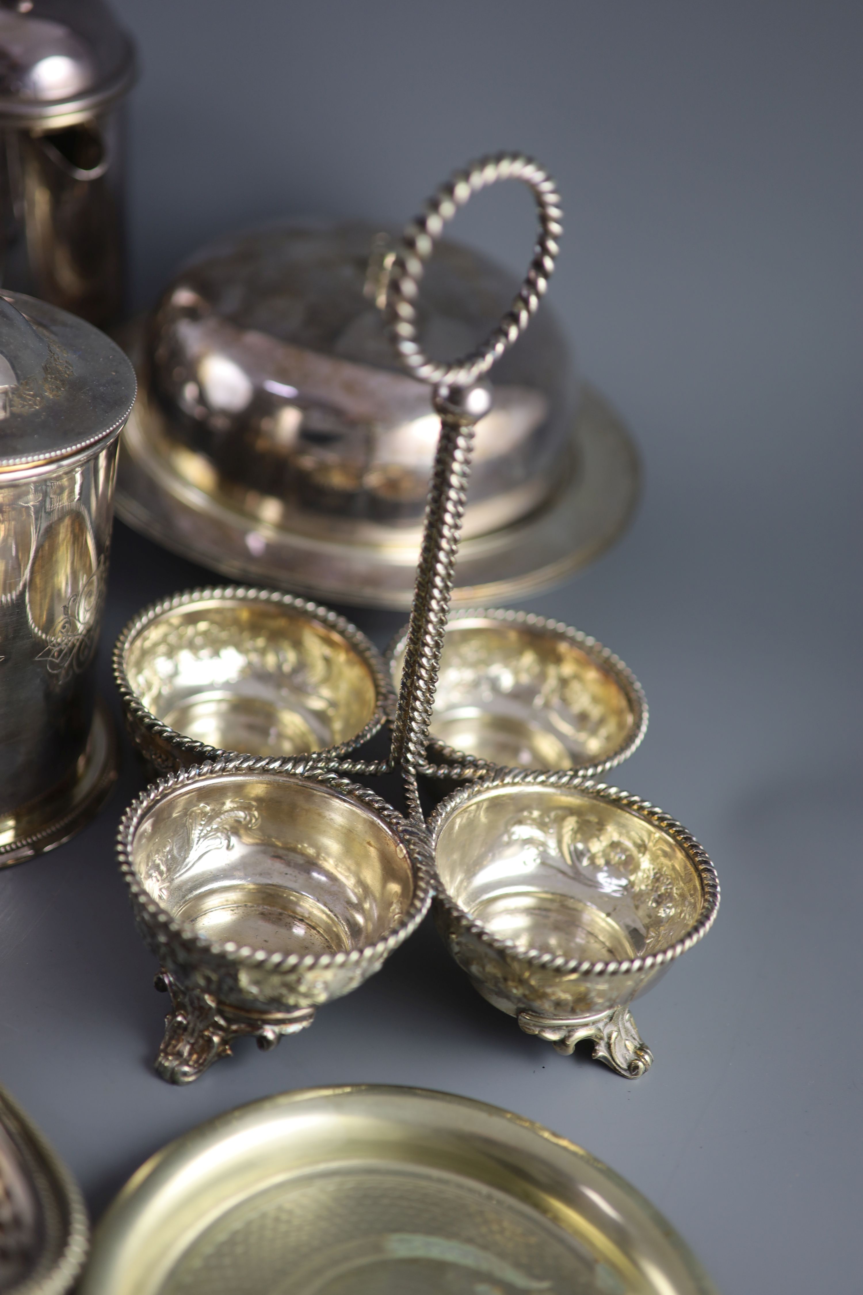 A silver plated egg cruet, a butter dish, a table salt and sundry other plated wares